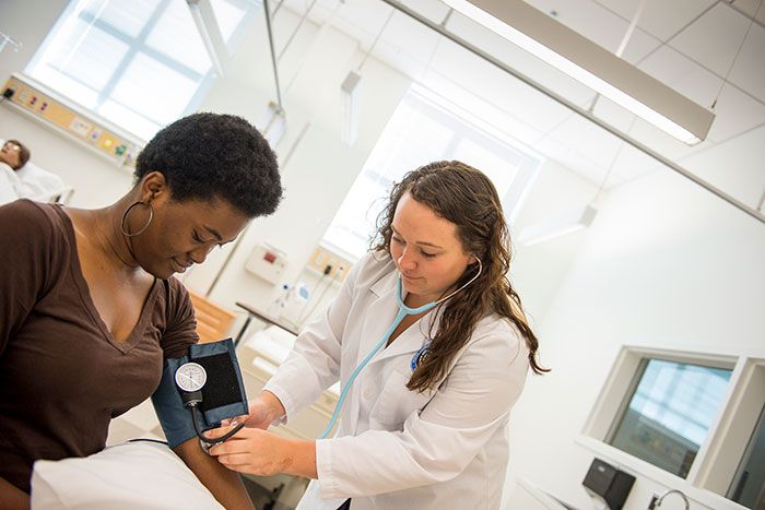 two nursing students in NDMU skills lab