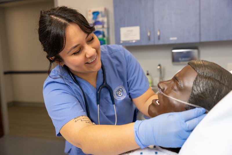 Nursing student working with manikin