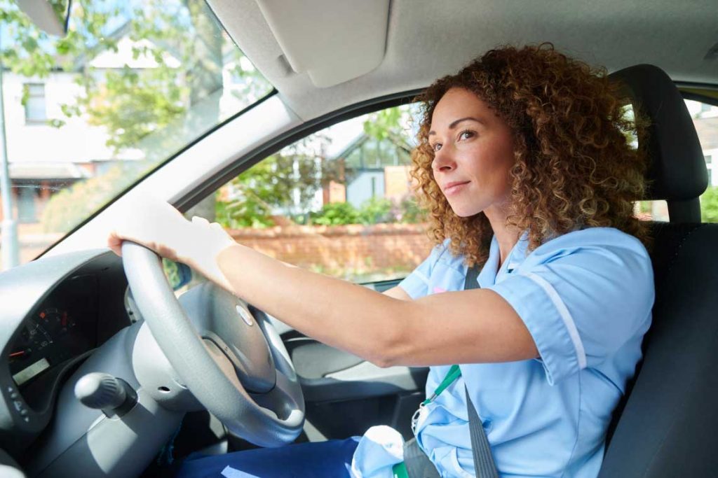 nurse in car looking out window
