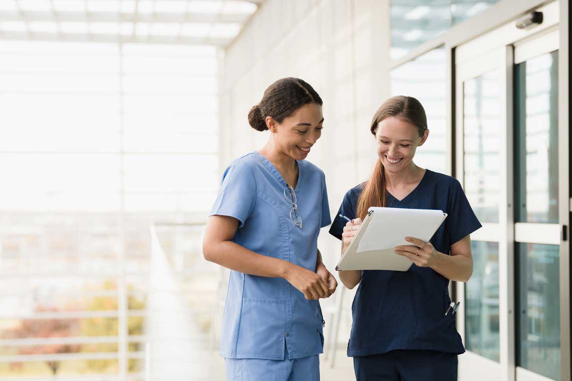 two nurses talking in hallway