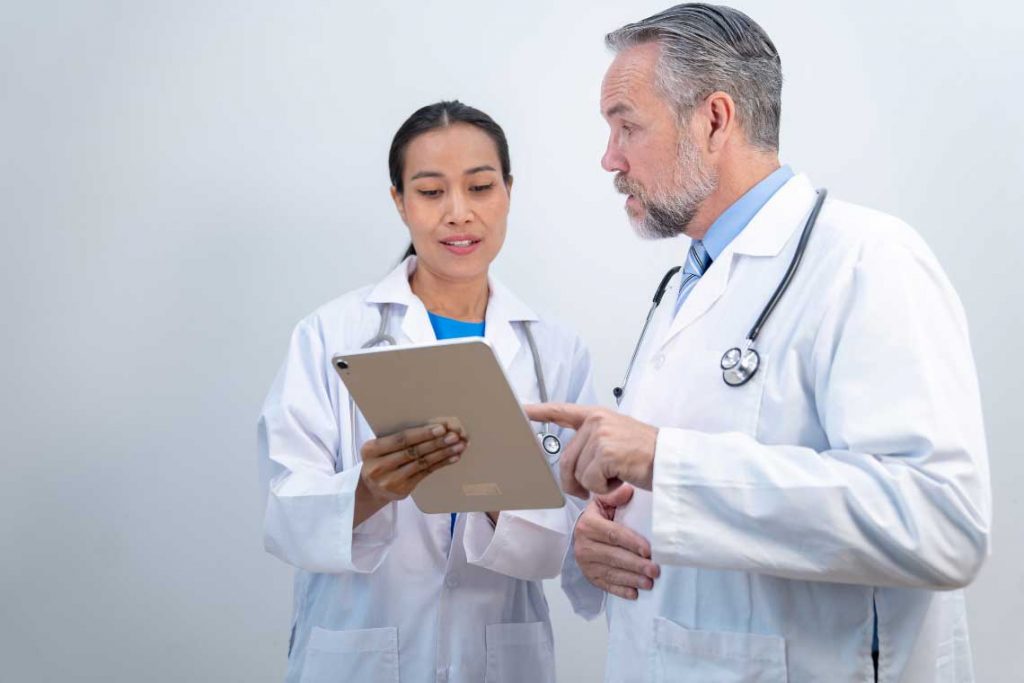 nurses talking and holding clipboard
