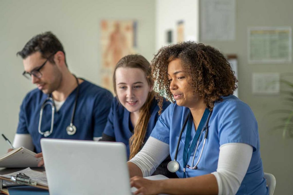 nurses looking at laptop screen