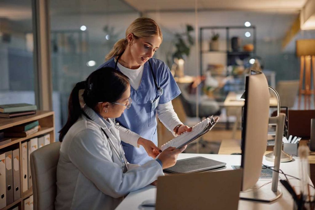 nurses looking at clipboard
